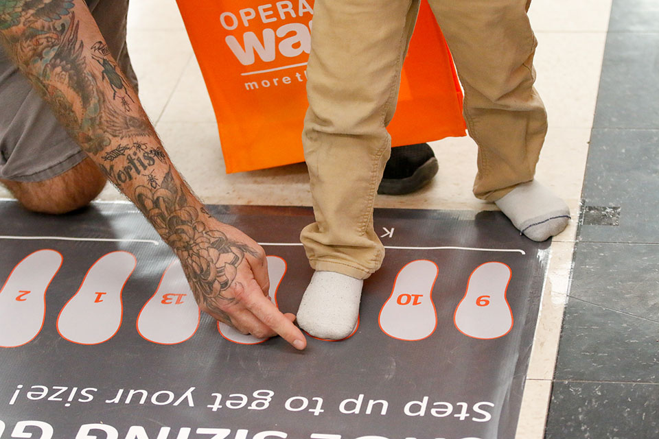A boy has his foot measured for a new pair of shoes
