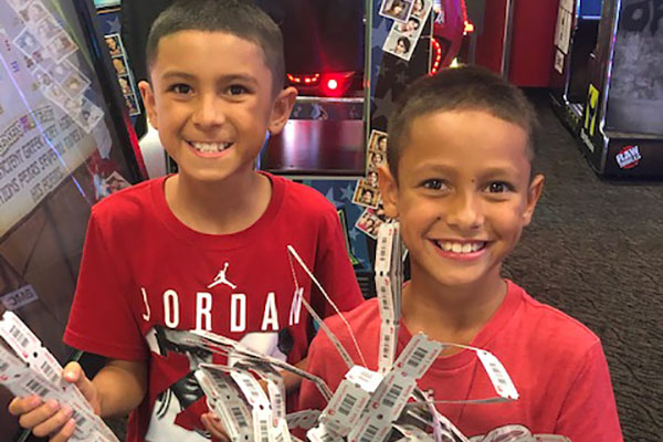 Two Young Boys Holding Raffle Tickets