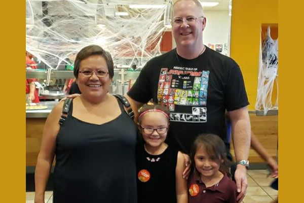 Two Parents and Two Kids At A PTC Event